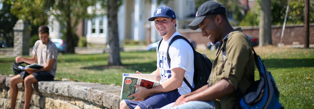 garrett brown and carlos sitting on wall outside smeal building at Penn State DuBois