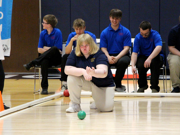 One of the athletes from NorthPenn-Mansfield watches as her throw rolls down the court at the PAW Center during the interscholastic unified sports bocce regional championship