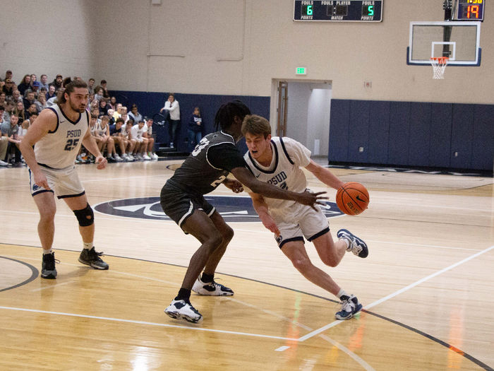 Penn State DuBois junior forward Will Helton drives past the reach of his defender during the contest with Penn State New Kensington at the PAW Center