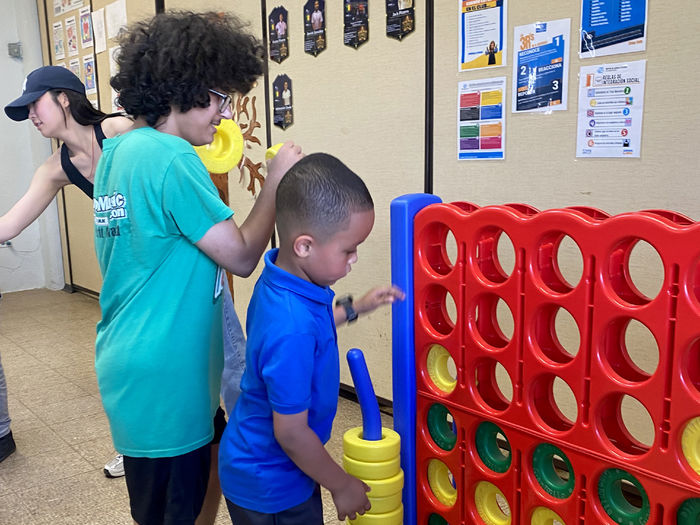 Penn State DuBois student Melakai Forrest interacts with a school-aged child at the Boys and Girls Club of Puerto Rico during the alternative spring break trip.