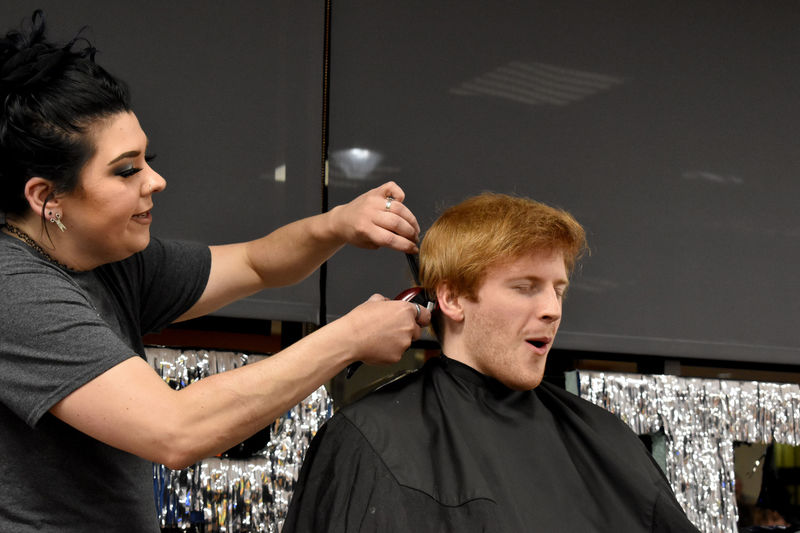 Eamon Jamieson feels the clippers for the first time as his head gets buzzed during the THON hair auction