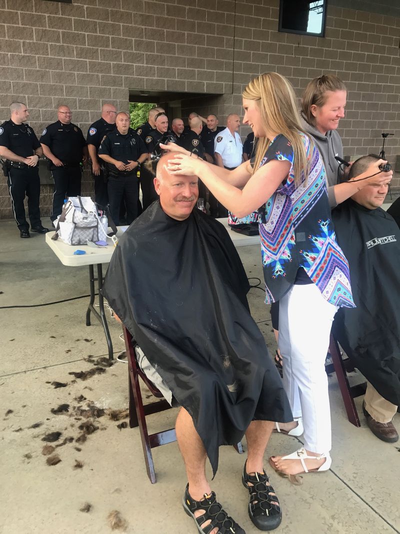 Campus police officer John Licatovich gets a buzz cut for "Buzz for Brock"