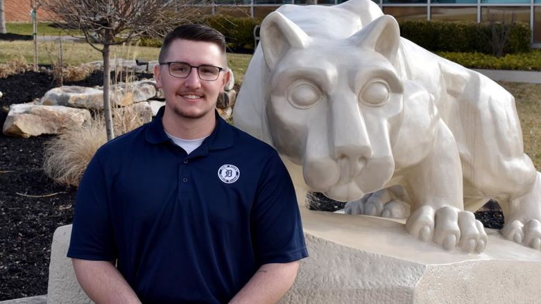 Lukas Salvo with the Lion Shrine on the campus of Penn State DuBois