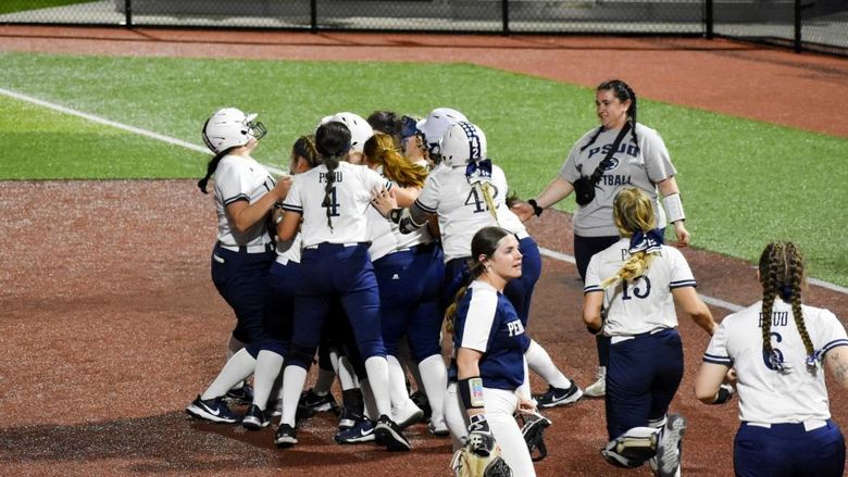 The Penn State DuBois softball team rush the field to celebrate a walk off win against Penn State Fayette at Heindl Field in DuBois