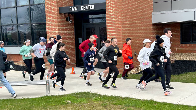 Participants in the Lion 5K Run/Walk cross the starting line near the PAW Center. The 5K took place as part of We Are Weekend at Penn State DuBois.