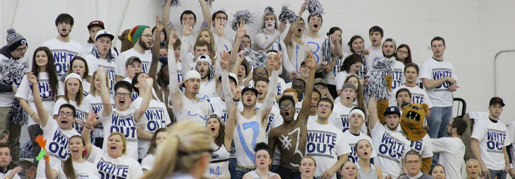 picture of students at white out basketball game cheering