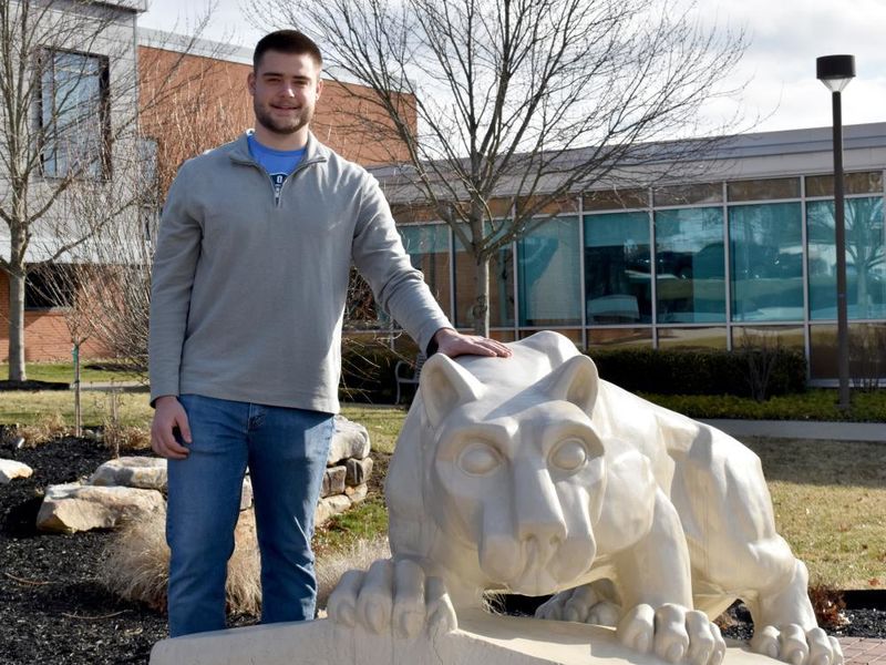 Dylan Treaster with the Lion Shrine on the campus of Penn State DuBois