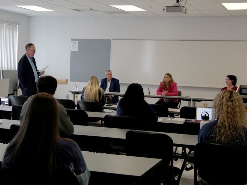 Members of the entrepreneur panel at Penn State DuBois receive an introduction from Brad Lashinsky, far left. Panel members seated at the table in front, from left to right, Michael Clement, Paula Foradora and Jennifer Reynolds-Hamilton.