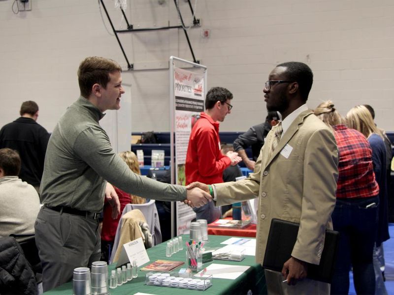 Kane Witter, right, shakes the hand of an employer representative during last year’s career fair at Penn State DuBois in the PAW Center.