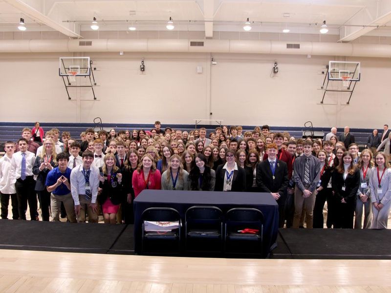 All students who participated in the 2024 Pennsylvania DECA District 1 conference gather for a group photo on the gym floor at the PAW Center, on the campus of Penn State DuBois.