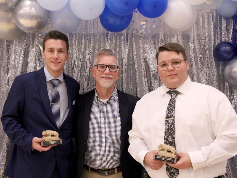 Penn State DuBois students Garret Park, left, and Elliot Park, right, stand for a photo with Scott Muirhead, lecturer of business administration, during the annual Recognition and Awards Banquet at Penn State DuBois.