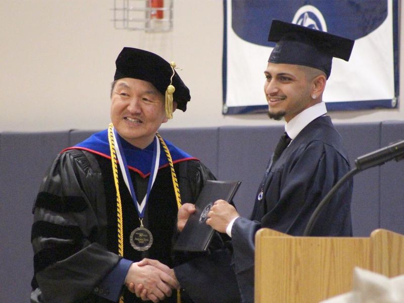 New Penn State graduate Ashwin Upadhyaya, who earned a bachelor’s degree of science in business, receives his diploma from Jungwoo Ryoo, chancellor and chief academic officer, during the spring commencement ceremony at Penn State DuBois.