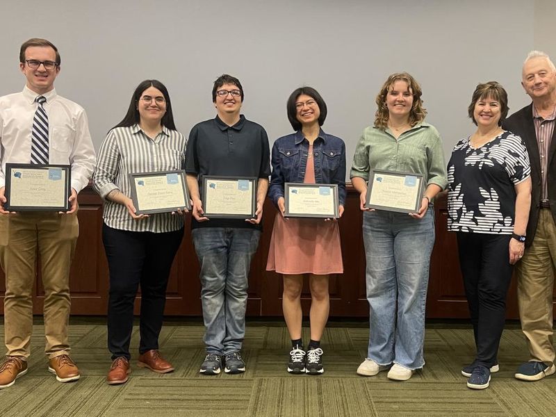 5 students holding awards standing next to John Sr. and Kimlyn Patishnock 