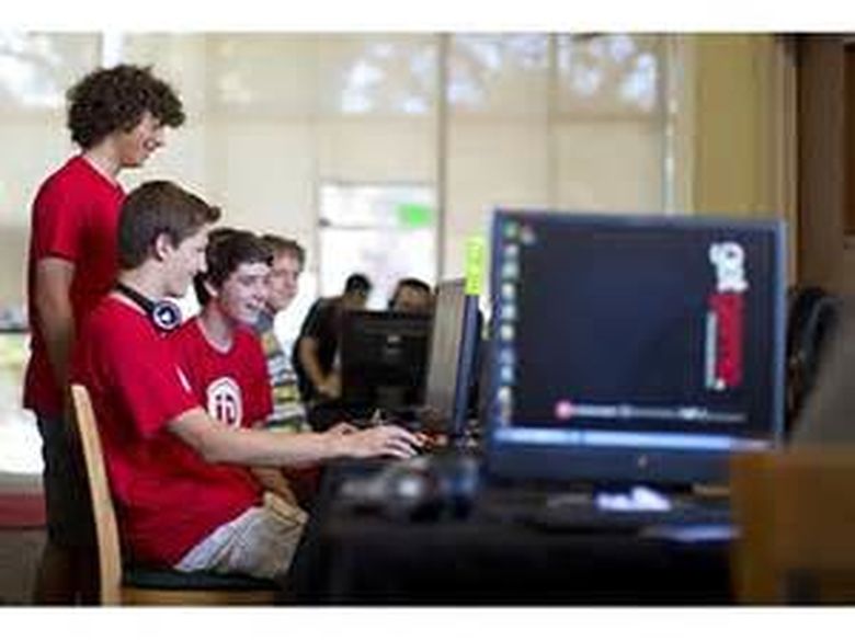 Four students seated at computers