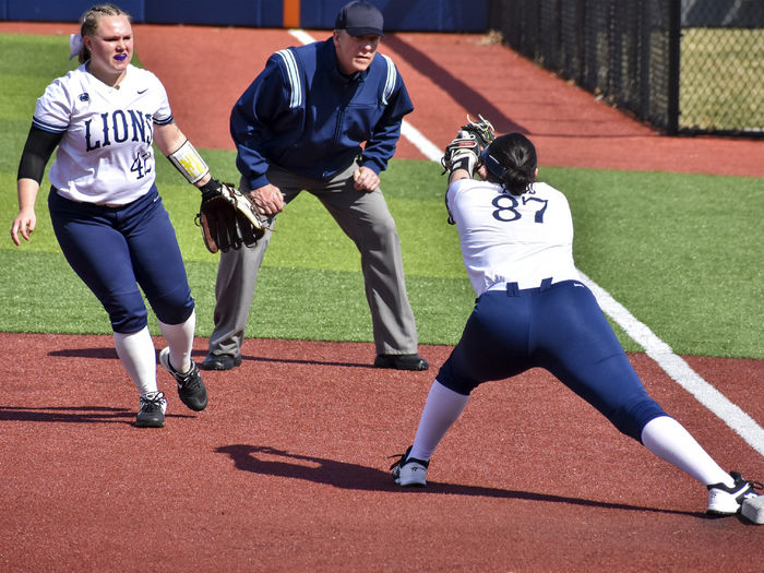Penn State DuBois infielder Paige Pleta (42) completes a flip to teammate Shyanne Lundy (87) covering first base to record an out during a softball game last year at Heindl Memorial Field