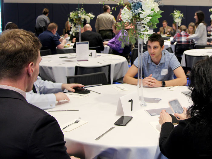 Carter Lindemuth, a junior at Penn State DuBois, has a conversation with professionals and employers at the table during the networking luncheon at the PAW Center
