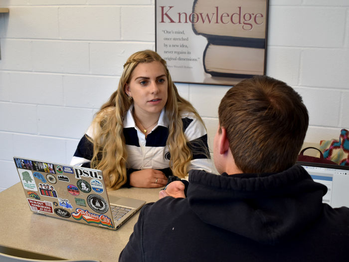 Larissa James-LaBranche helping a student as a tutor at the center for undergraduate excellence, also known as “The CUE”, at Penn State DuBois