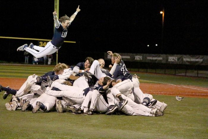 Penn State DuBois players celebrate winning the national championship with a dog pile near the pitcher’s mound at Shower Field