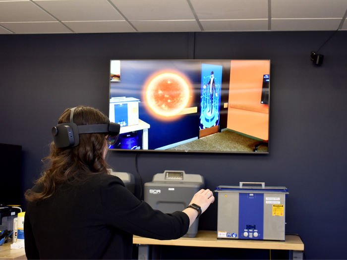 Penn State DuBois alumna Anna Raffeinner uses the augmented reality capabilities in the Idea Lab to explore the solar system.