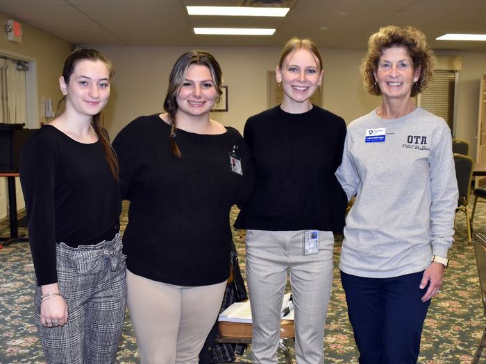 Occupational Therapy Assistant (OTA) students Maddie Barsh, Emily Busija, and Fiona Riss present with LuAnn Delbrugge, program coordinator and associate teaching professor for OTA.