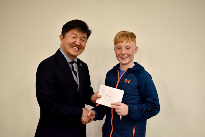 Kai Caskey of Saint Marys, right, receives the individual award for the preliminary round from Jungwoo Ryoo, chancellor and chief academic officer of Penn State DuBois