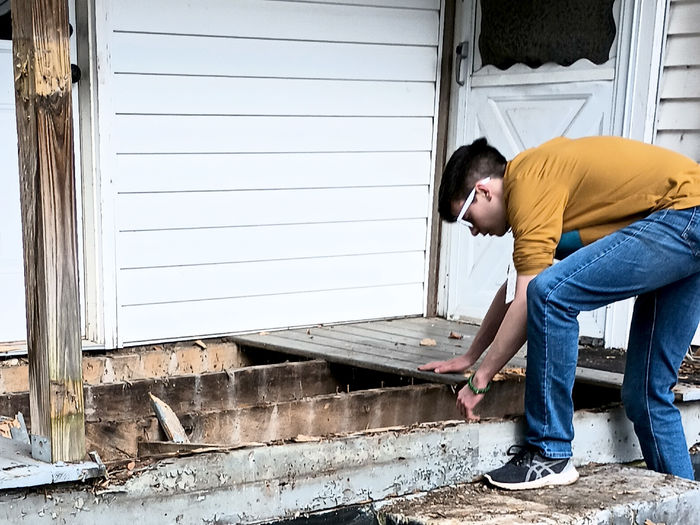 -	Penn State DuBois student Remington Crawford works hard on a home repair project during the spring break service trip to Kentucky through the Christian Student Fellowship organization at Penn State DuBois.