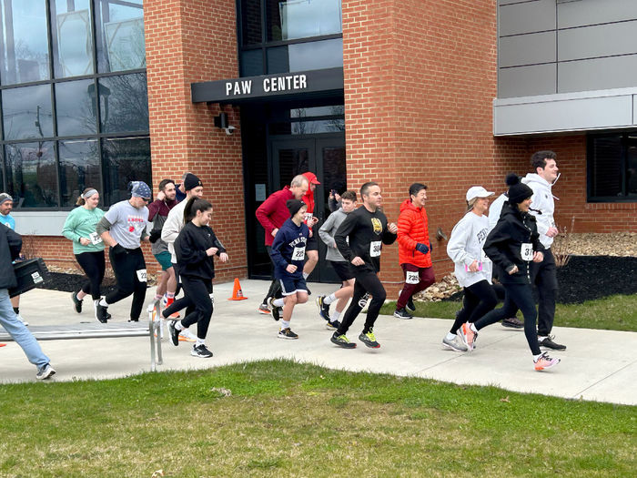 Participants in the Lion 5K Run/Walk cross the starting line near the PAW Center. The 5K took place as part of We Are Weekend at Penn State DuBois.