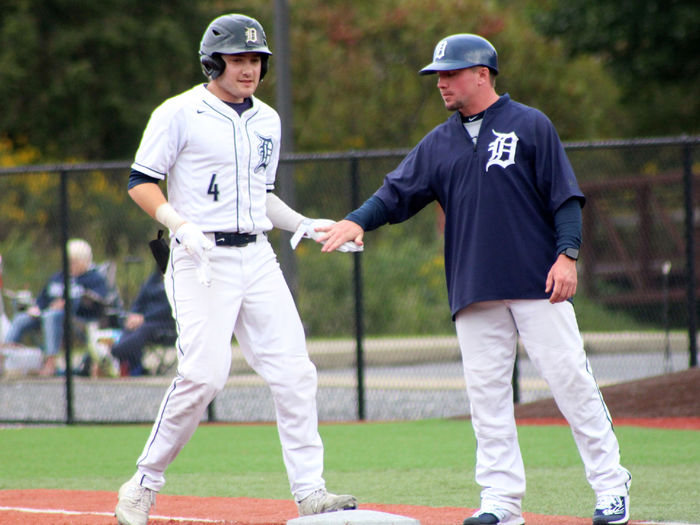 Penn State DuBois baseball coach Garrett Brown congratulates senior Brandon Sicheri after reaching base during a game in the 2023-24 season. Brown has now been named the new head coach of Penn State DuBois baseball.