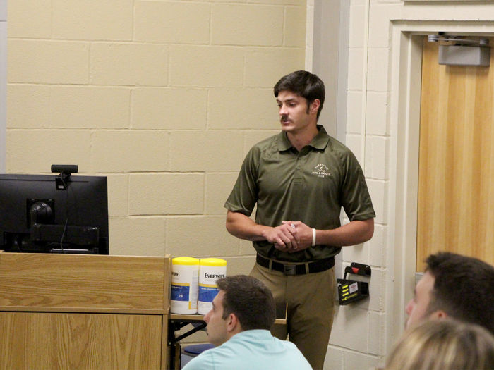 Penn State DuBois student Grant Grimaldi reviews his presentation slide while sharing his internship experience with those gathered in the Swift building, on the campus of Penn State DuBois.