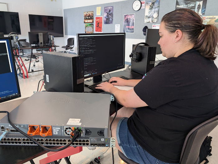 Penn State DuBois student Abagail Kellogg-Long works through the initial setup of a Juniper switch before installation of the device in the IST lab on campus.