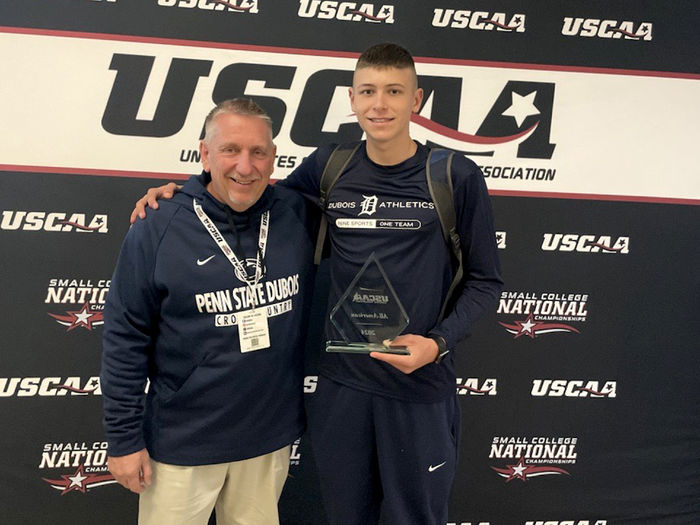 Penn State DuBois cross-country athlete Jack Craig, right, joins head coach Scott Creighton for a photo with his award for finishing sixth national at the USCAA National Championships.