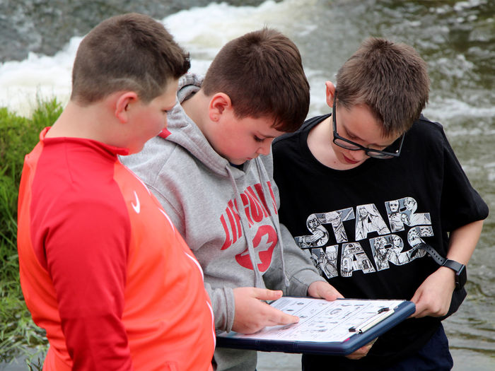 Students from Juniata Elementary in DuBois work on identifying some of the organisms that were found during the wetlands program held at the school in May.