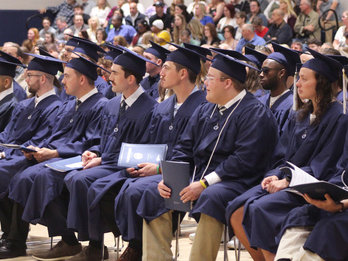Soon to be Penn State graduates listen to commencement speaker, Daniel Kohlhepp, during the spring commencement ceremony at Penn State DuBois.