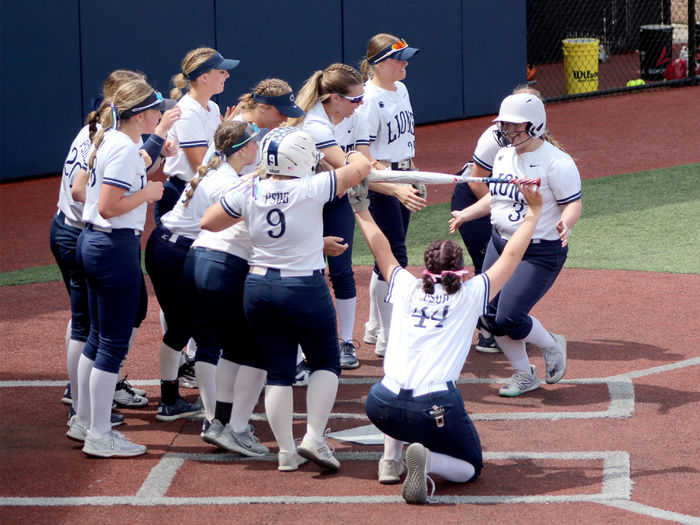 Penn State DuBois senior designated player Chelsea Busatto is congratulated by her teammates at home plate after hitting a home run during a game in the USCAA Small College World Series, held at Heindl Field in DuBois.