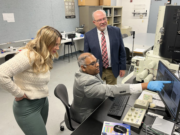 Ramakrishnan Rajagopalan, professor of engineering at Penn State DuBois, demonstrates how some equipment and processes work within one of the engineering labs at Penn State DuBois. Tony Zaffuto, founder and president, right, and Bethany Zaffuto, marketer, left, from Metaltech look on during the demonstration.