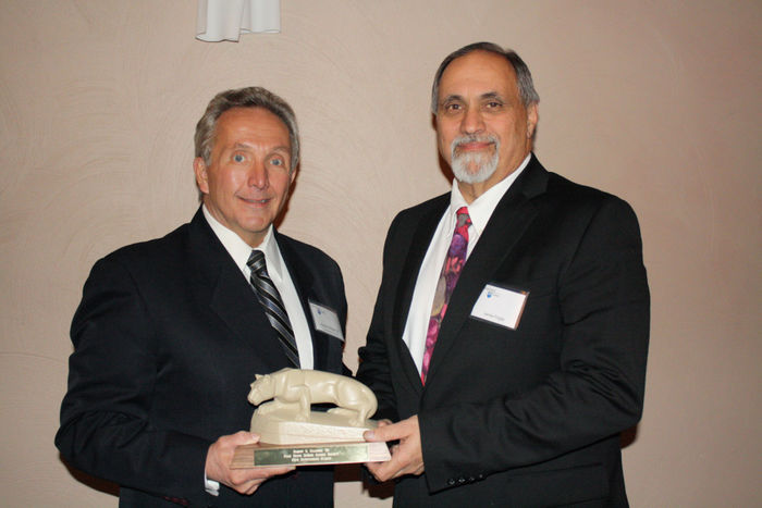 Bob Ellinger '80 receives the the Outstanding Alumni Award from Jim Fragle