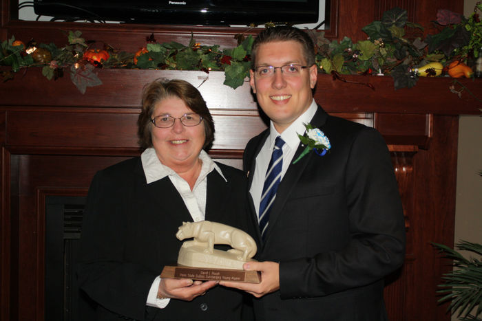 David Roush '04 accepting the 2013 Outstanding Young Alumni Award from Diane Bernardo