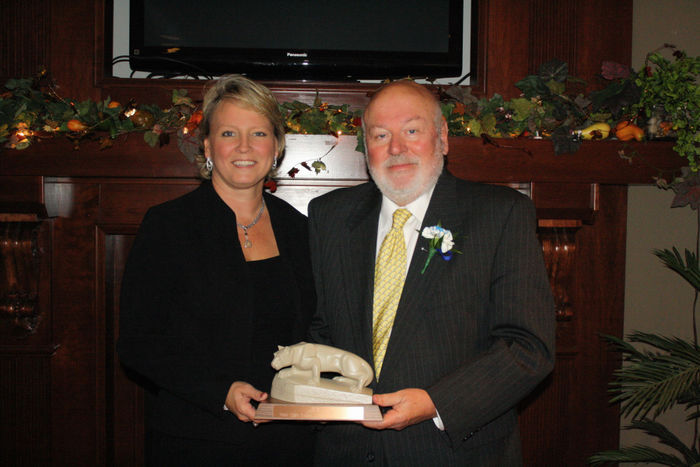 John Beam accepting the 2013 Distinguished Ambassador Award from Jean Wolf