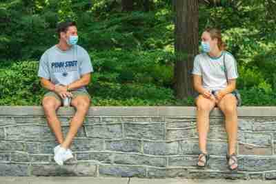 Two students socially distanced wearing masks