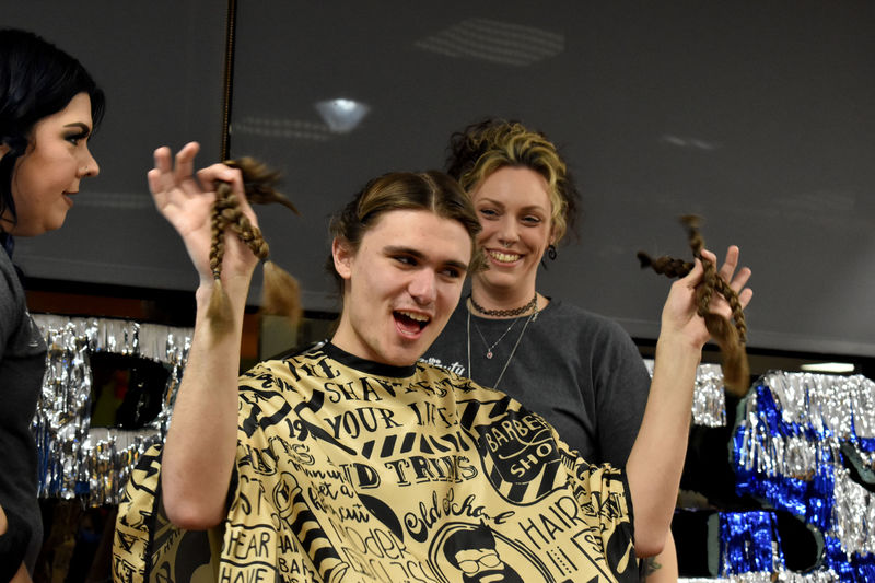 Penn State DuBois student and THON dancer Gaven Wolfgang proudly displays his freshly cut hair at the hair auction