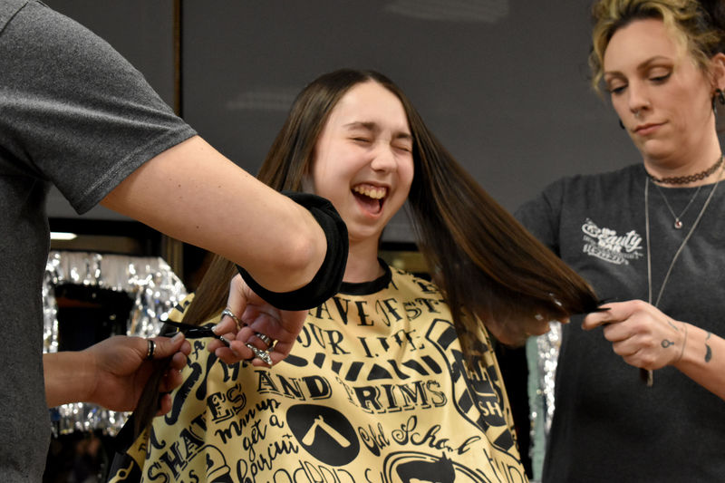Elise Dufour shows her excitement as her hair is cut during the THON hair auction