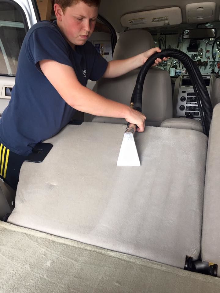Kristy Hanes, works to detail the interior of a customer's car at her business. 