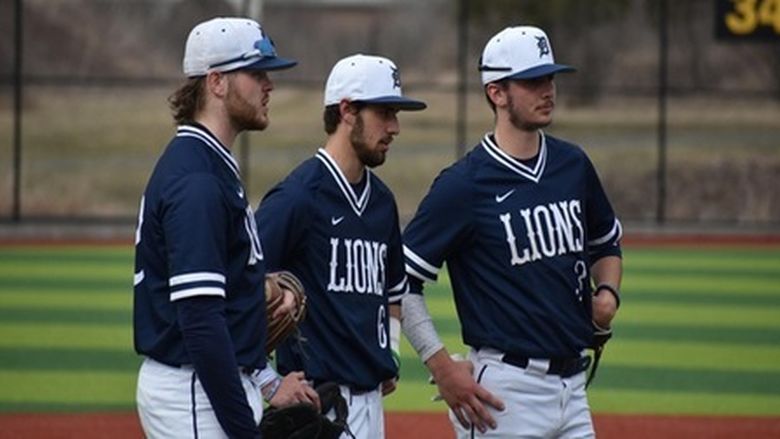 three Penn State DuBois baseball players talk at the pitching mound