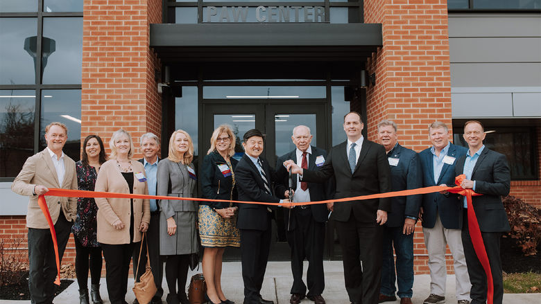 Ribbon cutting in front of the PAW Center building at Penn State DuBois