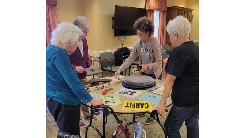 LuAnn Delbrugge presents residents of Windy Hill Village with information at a CarFit event.