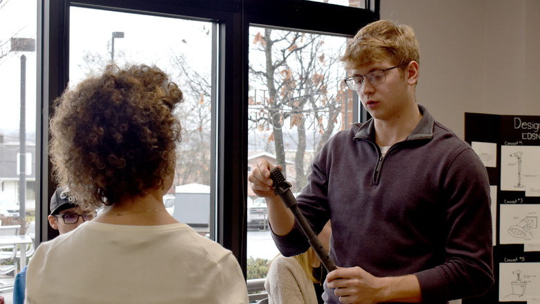 Jalen Kosko, Penn State DuBois freshman mechanical engineering student, presents the prototype for his group at the collaboration projects presentation