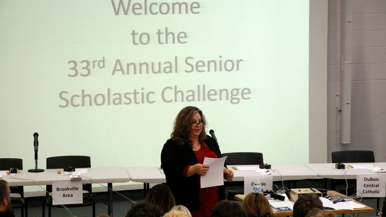 Carol Foltz of Coldwell Banker Developac Realty gives instructions to those in attendance in the Hiller Auditorium during the junior scholastic challenge