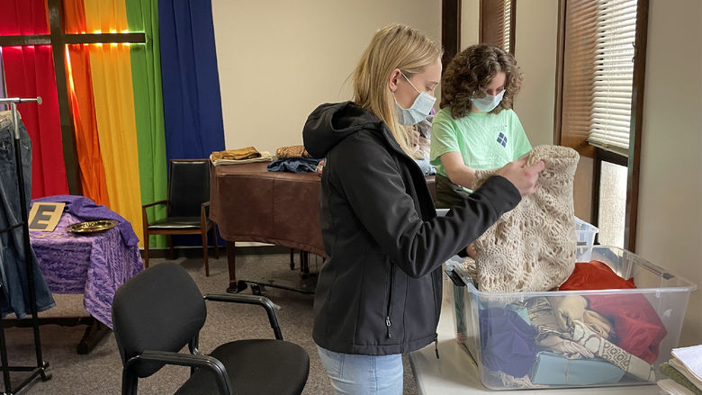 Students sort through donation boxes as part of their service on their alternative spring break trip this spring