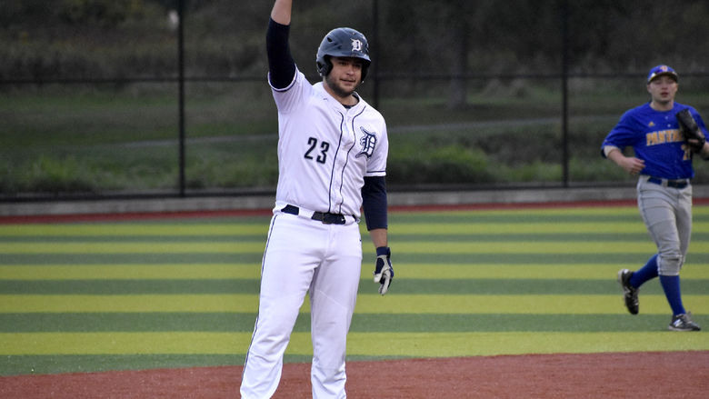 Dylan Treaster celebrates a double and signals to his teammates in the dugout during a home game at Showers Field in DuBois