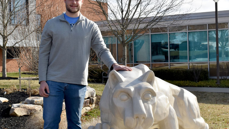 Dylan Treaster with the Lion Shrine on the campus of Penn State DuBois